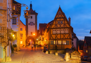 Naklejka na ściany i meble illuminated night street in Rothenburg ob der Tauber, Germany