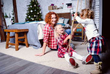 Modern family mother and children daughter christmas winter portrait. Decorated christmas tree, cozy atmosphere living room. Family Together Celebration Concept. Merry Christmas and Happy Holidays