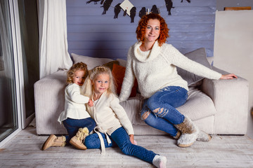 Modern family mother and children daughter christmas winter portrait. Decorated christmas tree, cozy atmosphere living room. Family Together Celebration Concept. Merry Christmas and Happy Holidays