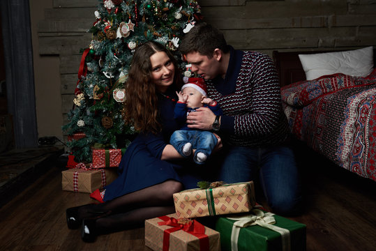 Happy Caucasian Family Posing In Studio With Christmas Tree