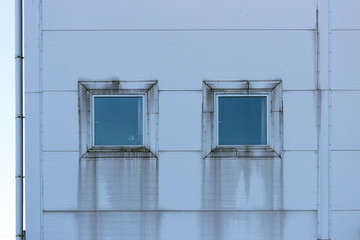 two square windows with siding imitating steel, on large sports complex