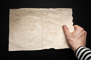 Strong sailor hand holds empty old map