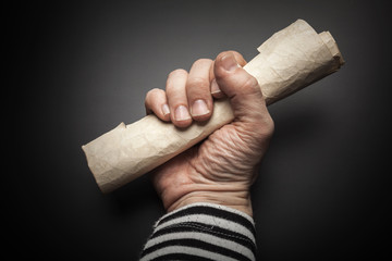 Strong sailor hand holds rolled map
