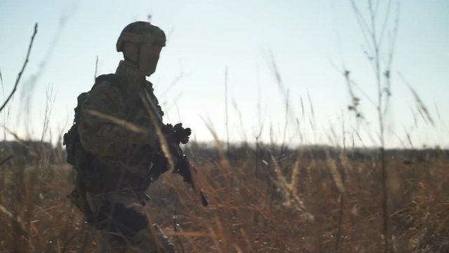 Soldier using smartphone during military simulation airsoft training game