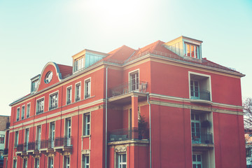 Obraz premium red residential building with 3 floors and beautiful windows