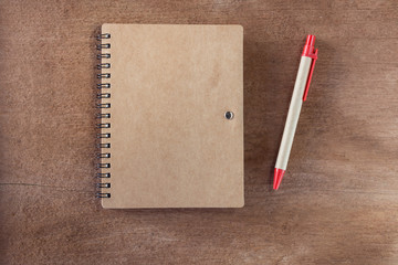 Blank Notebook With pen On Wooden Background