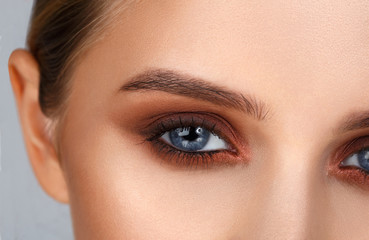 Close-up shot of female eye make-up in smoky eyes style