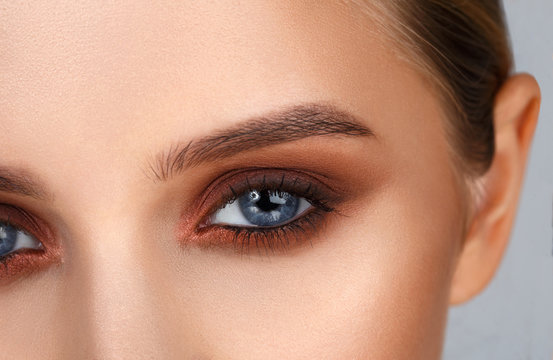 Close-up shot of female eye make-up in smoky eyes style