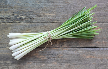 Fresh lemongrass (citronella) on wooden background - Spice for h