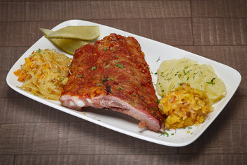 Medium grilled beef ribs served with mashed potatoes, cucumber a