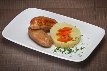 Homemade sausage and mashed potato on wooden table