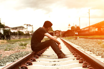 sad man sitting at trian