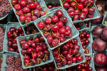 Aerial view of lots of cherries ready to eat, freshly caught and with the dew of the cold that covers them. Exhibitor of a Manhattan local market