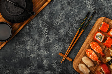 Sushi Set: sushi and sushi rolls on wooden plate.