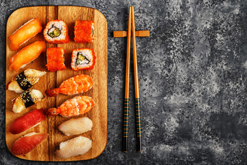 Sushi Set: sushi and sushi rolls on wooden plate.