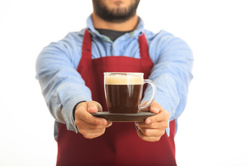 Young man offering a cup of coffee