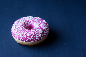 pink strawberry donut on a black background