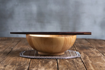 wooden bowls and chopsticks on wooden  table