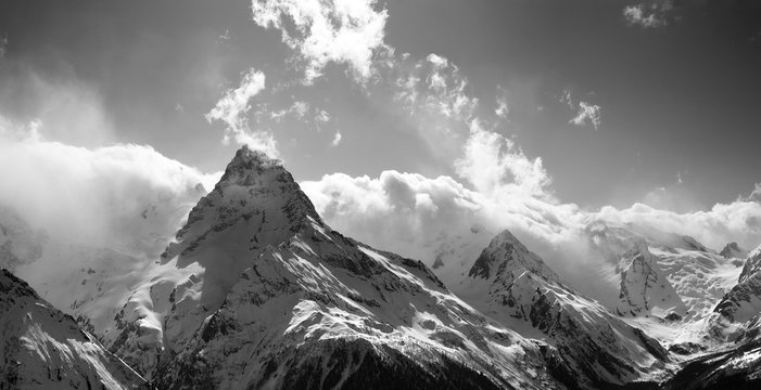 Black and white panorama of winter snow mountain at sun day