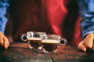 Fototapeta na wymiar Barista holding two espresso cups