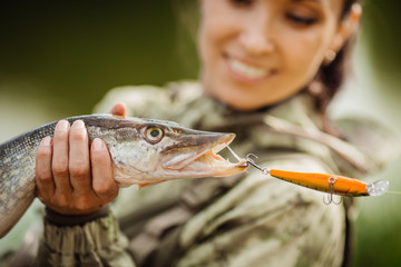 pretty woman fishes on the river