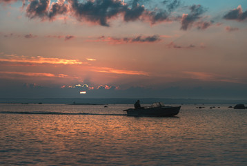 Fototapeta premium fisherman floats on a motorboat