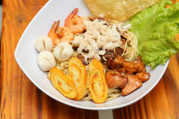 Crab noodles black pepper with prawn shrimp and vegetable in white bowl