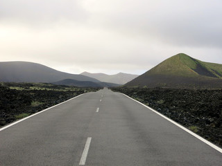 Wild road in a volcanic Landscape (Lanzarote, Canary Islands, Spain)