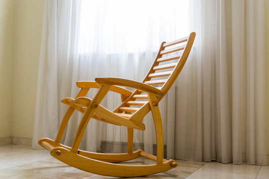 Wooden Rocking Chair Near The Window In Room