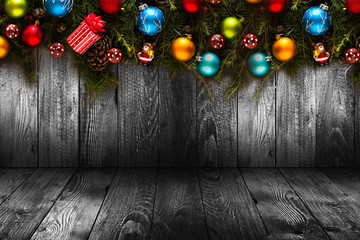 2017 Happy New Year seasonal background with real wood green pine, colorful Christmas baubles, gift boxe and other seasonal stuff over an old wooden aged background
