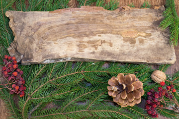 Wooden board on the Christmas tree branches