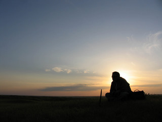 Fototapeta na wymiar A man sits on a sunset