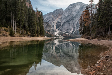 mountain lake with wooden house