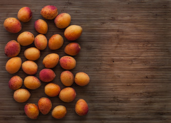 Apricots on the board background