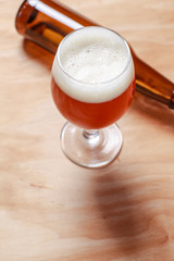 Beer glass and bottle on wood
