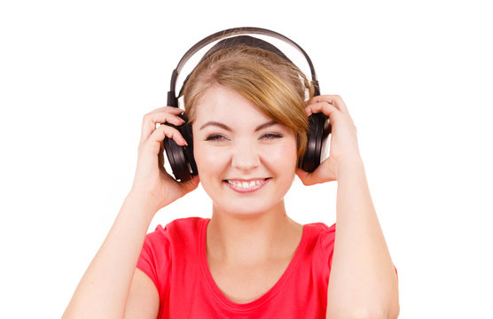 Woman in big headphones listening music isolated