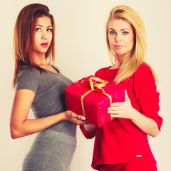 Two fashion women with red box gift.