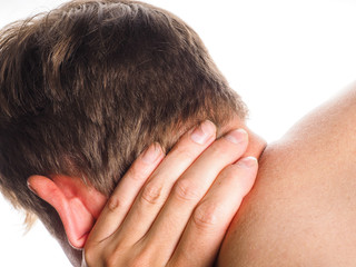 Fototapeta premium Unrecognizable man holding hand against neck, in pain, isolated