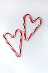 Two candy canes hearts on white