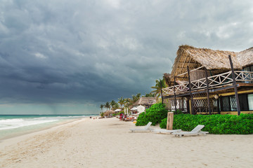 Bungalow hotel on the beach. Beautiful beach. Storm sky over the sea. Tulum, Mexico, Carribean
