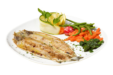 Grilled seabass fith with lemon, tomato and boiled vegetables on white background 