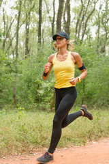 Female jogging. Sports training in forest