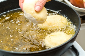 Donuts frying in deep fat