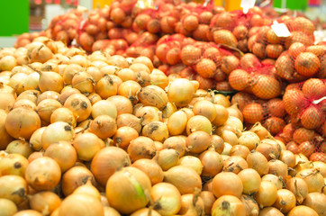 Naklejka na ściany i meble Close-up view pile of organic raw yellow onions