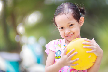 Cute child girl is smile with yellow ball,Hi key style and selec