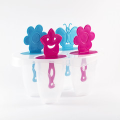 Popsicle molds on white background