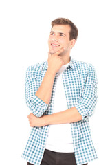 Portrait of smart smiling and thinking young man in plaid shirt. Copy space