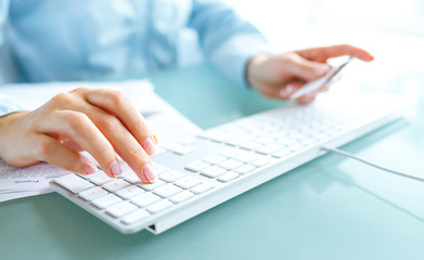 Hands using computer and credit card