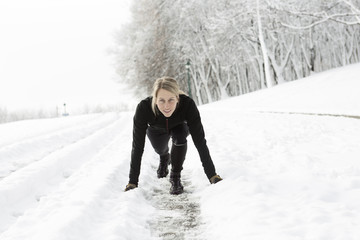 Fitness running woman in winter season