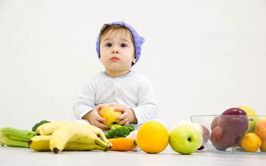 baby surrounded with fruits and vegetables, healthy child nutrition